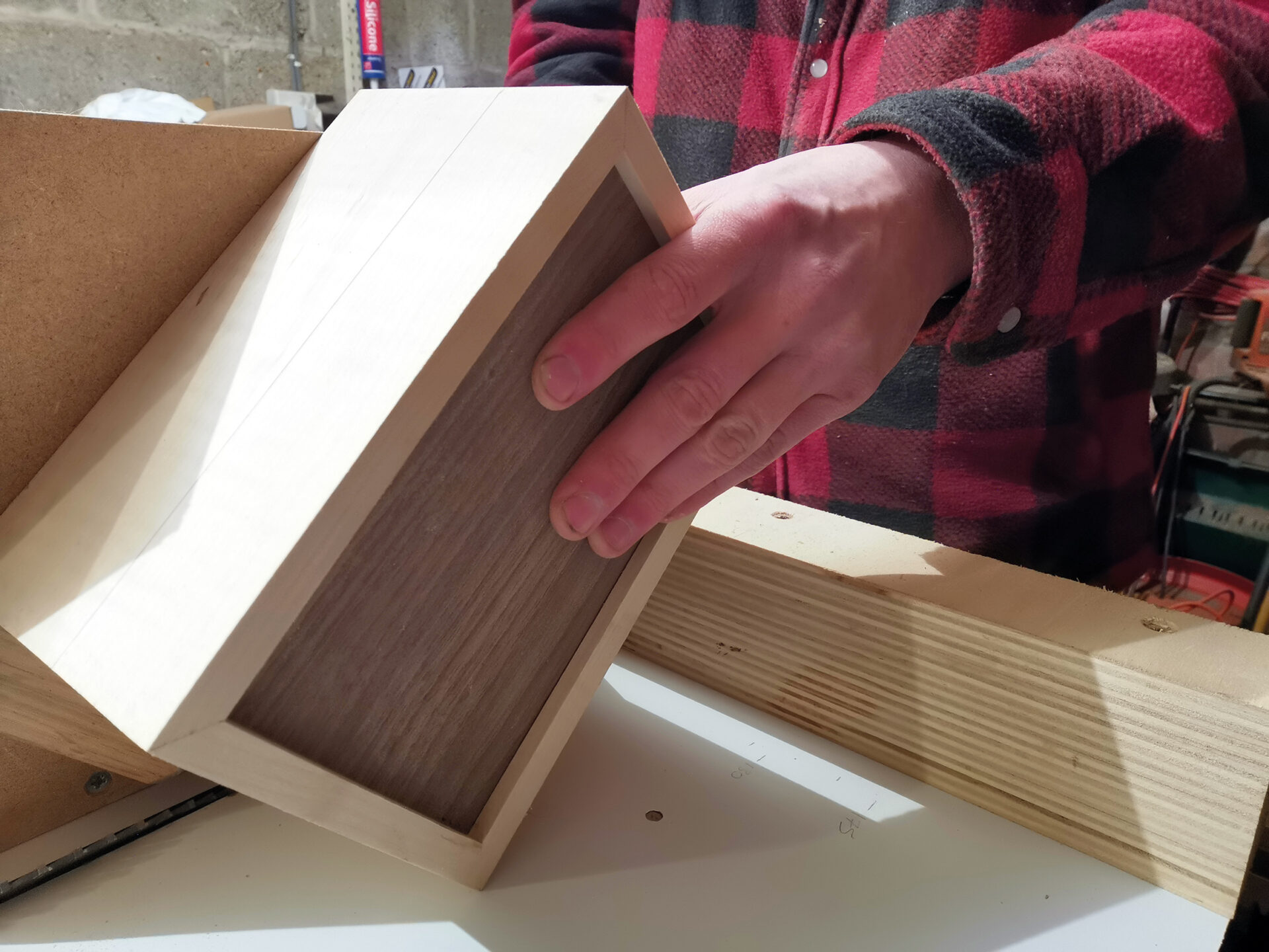 Person holding wooden box in workshop