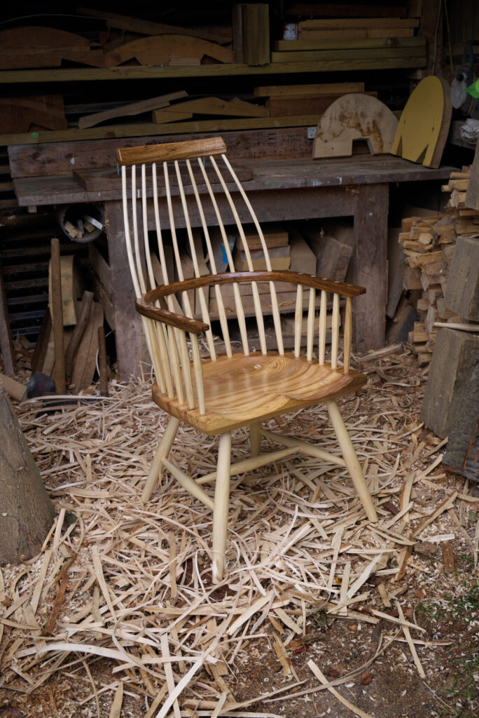 Handcrafted wooden chair in a rustic workshop.