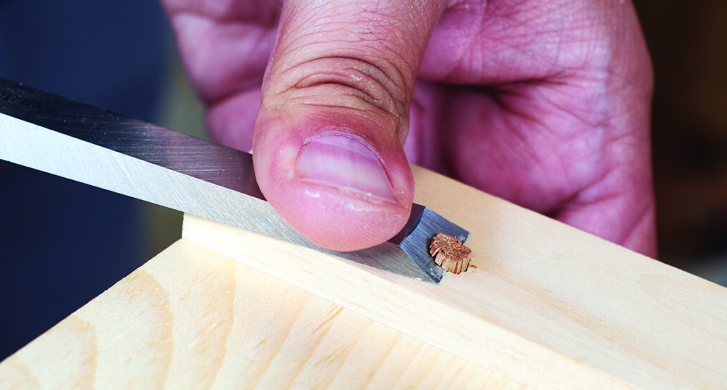Carving wood with chisel for woodworking precision