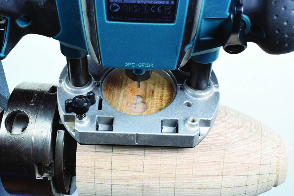 Wood router carving heart shape in wooden surface.