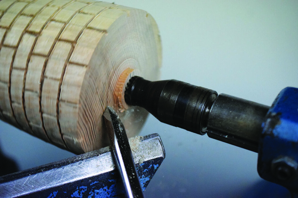 Lathe shaping wood with precision tool