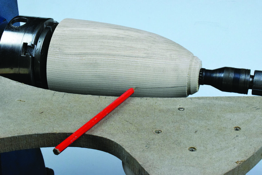 Woodturning tool shaping wooden piece on lathe