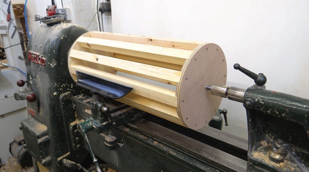 Wooden drum on a woodworking lathe machine.