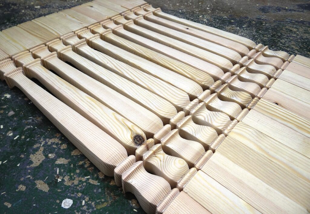 Carved wooden chair parts on workshop floor