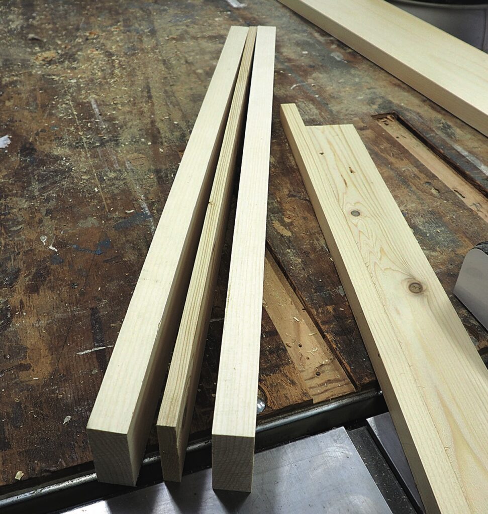 Cut wooden planks on a workshop table.