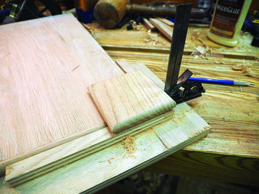Woodworking bench with woodglue and carpentry tools.