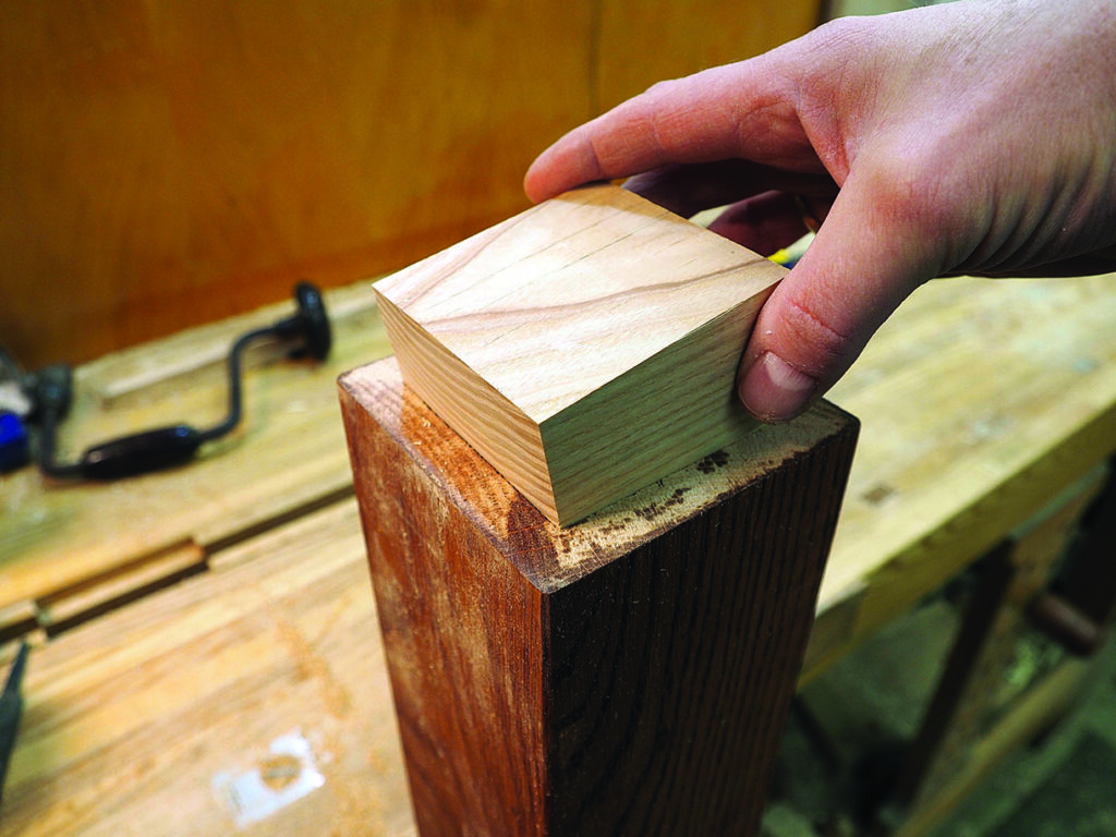 Hand crafting wooden joint on workbench