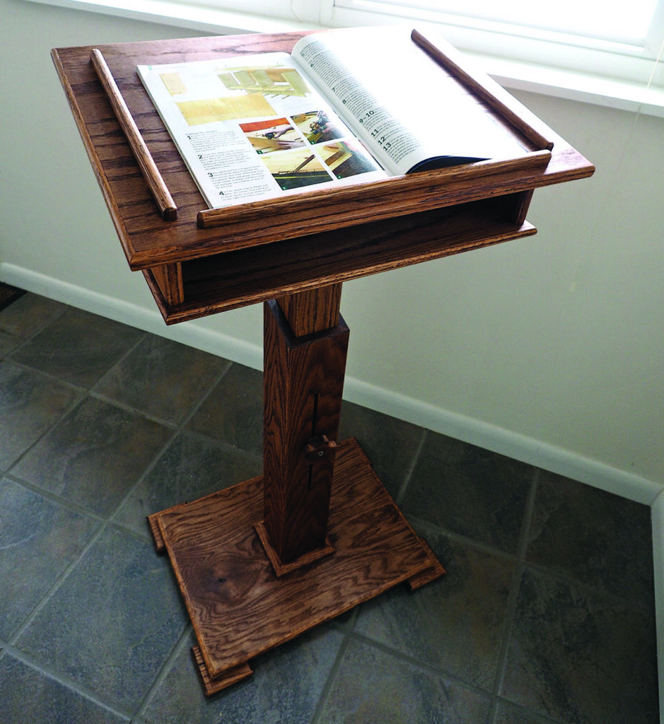 Wooden reading stand with open book near window.