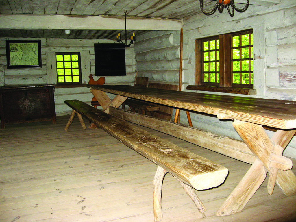 Rustic wooden dining room in a log cabin.