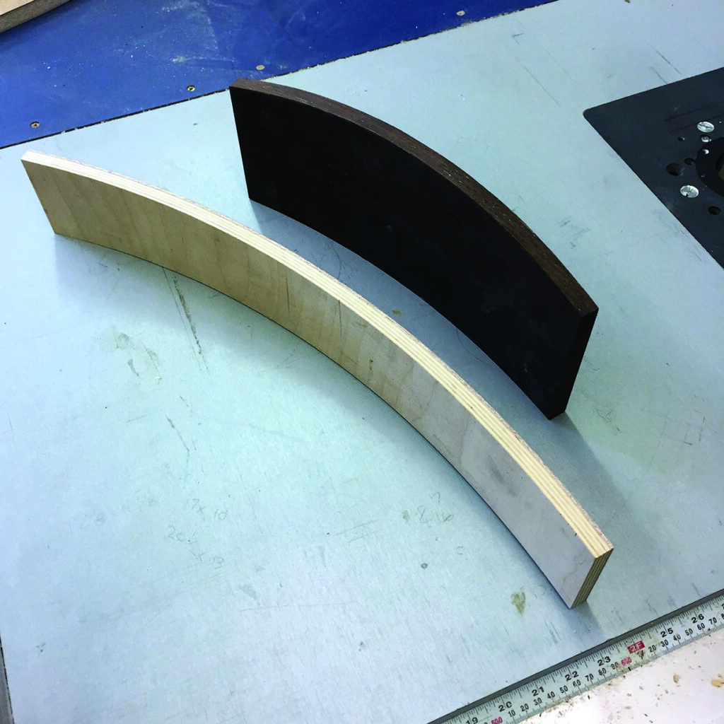 Curved wooden pieces on a workshop table.