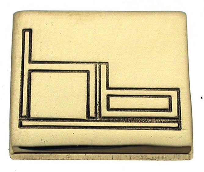 Golden buckle with abstract engraved design.