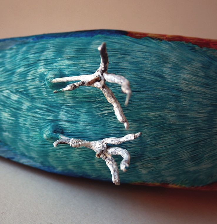 Sculpture of bird wings and claws on display.