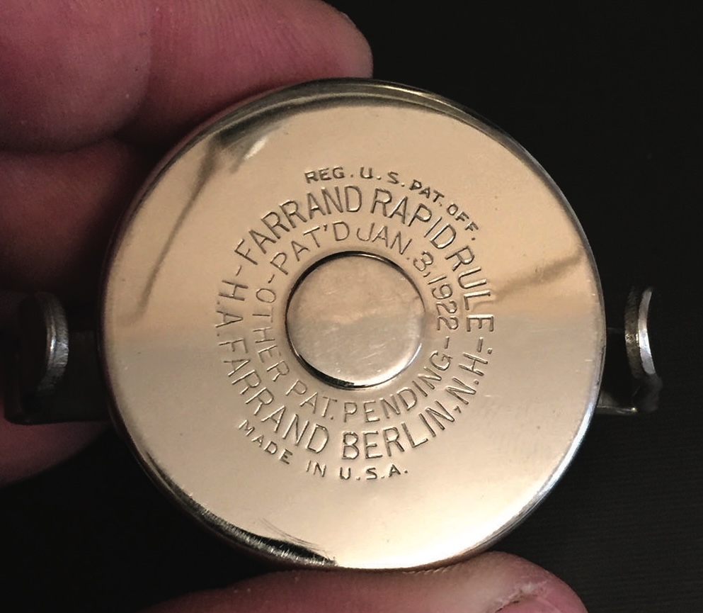 Vintage tape measure with engraved details.