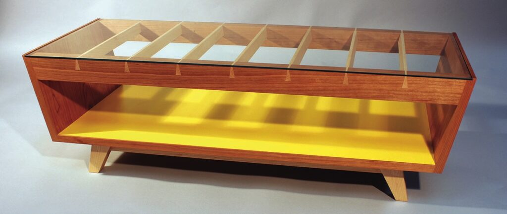 Modern wooden coffee table with glass top.