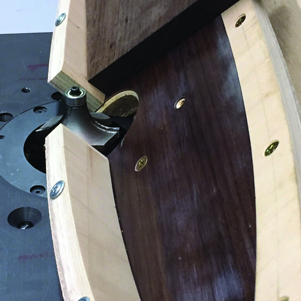 Woodworking setup with router and wooden guide.