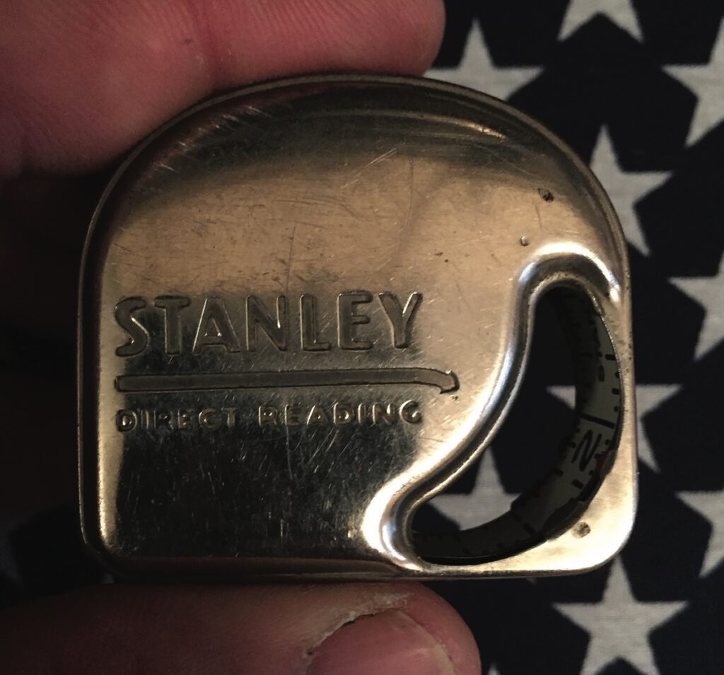 Vintage Stanley measuring tape on starry background.