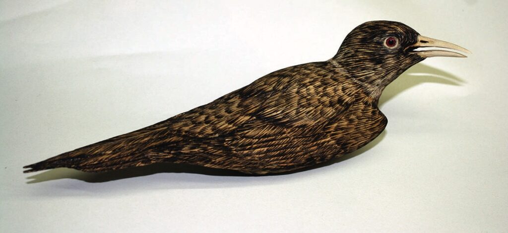 Intricately carved wooden bird sculpture