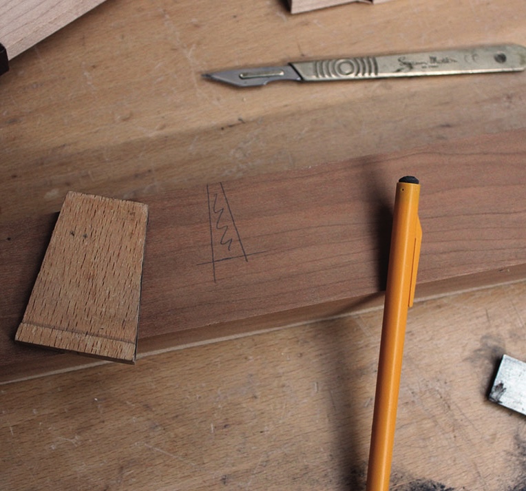 Woodwork joint layout with scalpel and pencil.