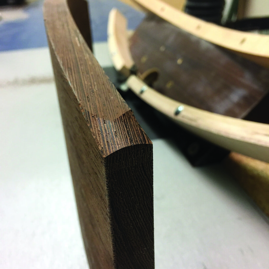 Close-up of carved wooden edges in workshop.