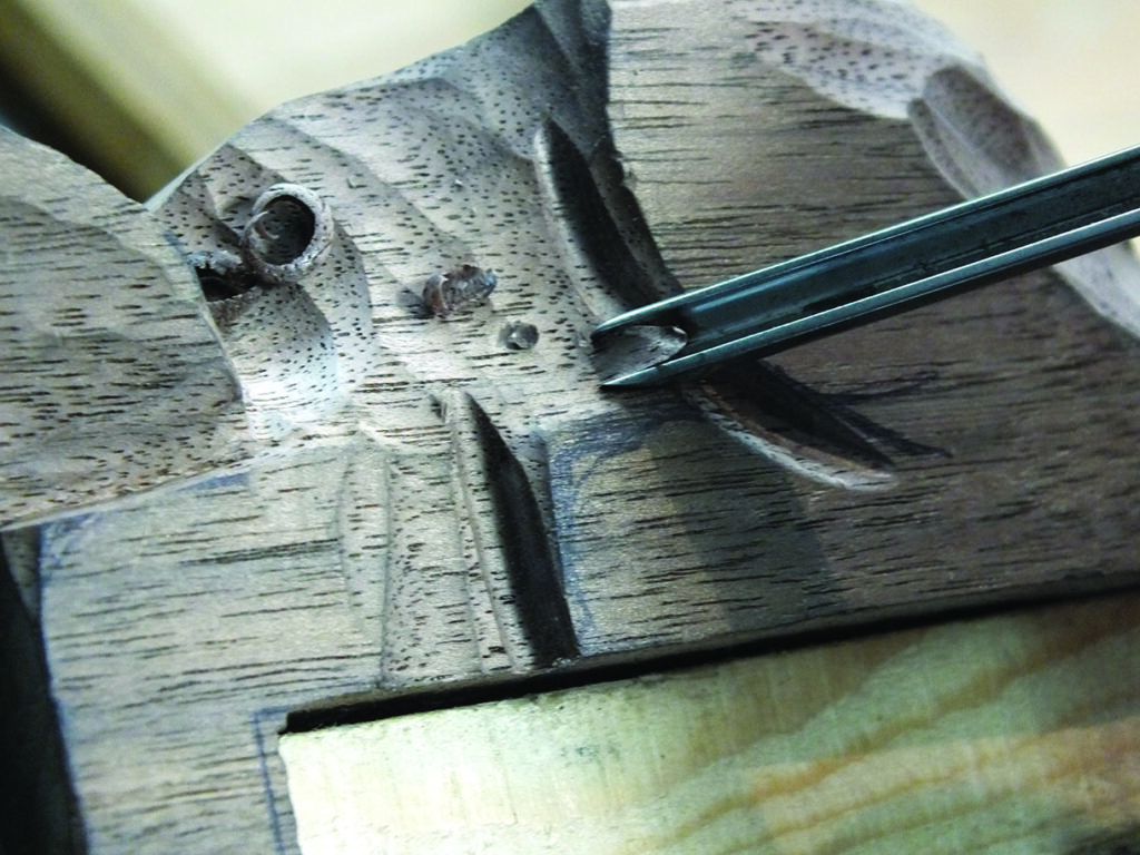 Wood carving detail with carving chisel.
