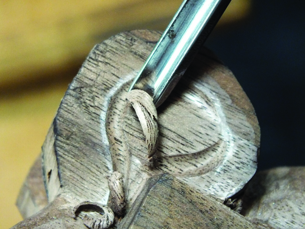 Close-up of wood carving with chisel tool