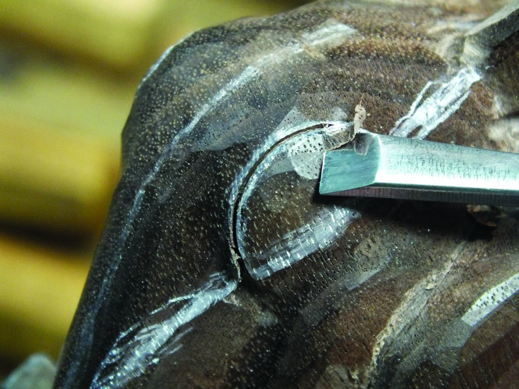 Close-up of wood carving with chisel