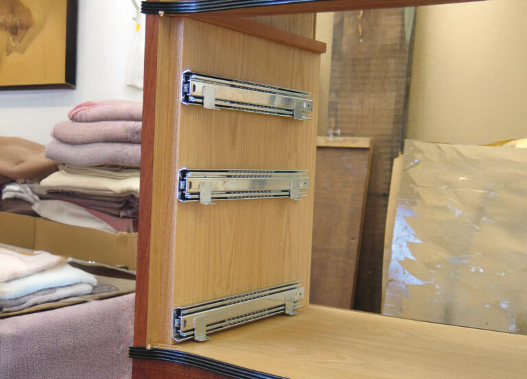 Wooden furniture with metal drawer sliders.