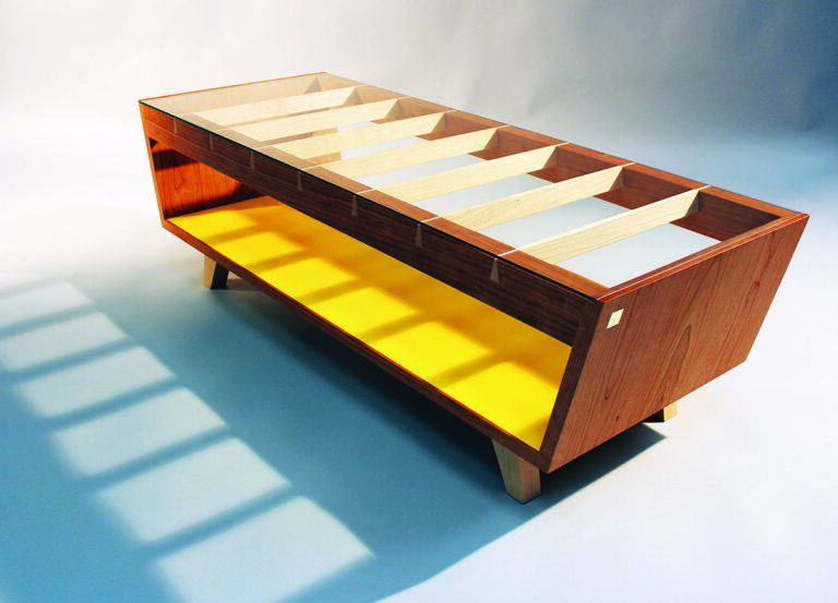 Modern wooden cabinet with glass top and shelves.