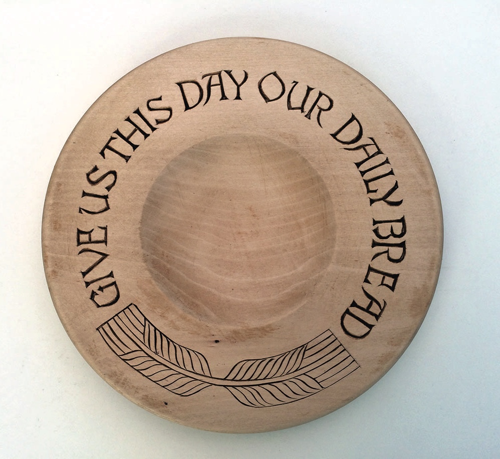 Bread platter with engraved prayer quote.