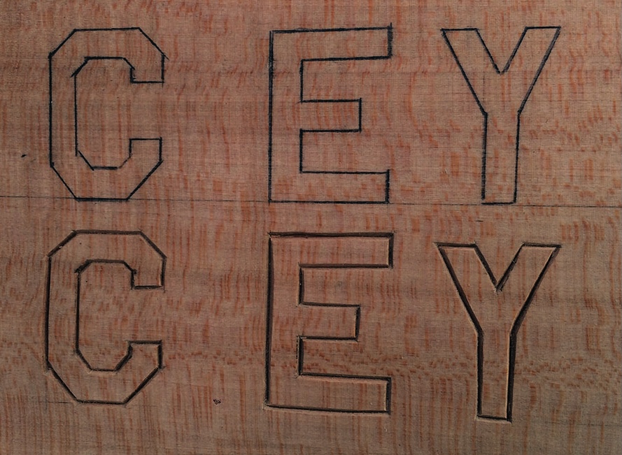 Wooden board with carved letters CEY