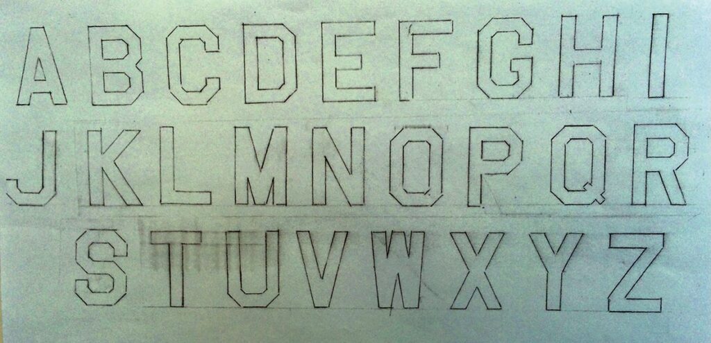 Outlined uppercase alphabet letters on paper.