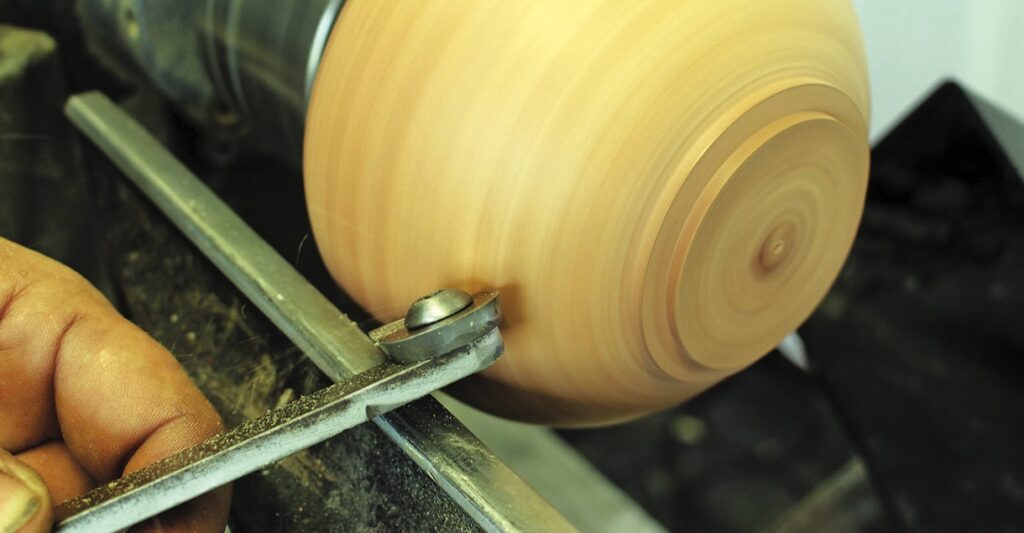 Close-up of wood turning on a lathe machine.