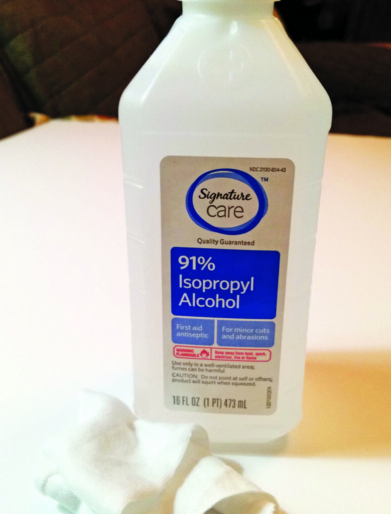 Bottle of 91% isopropyl alcohol on table.