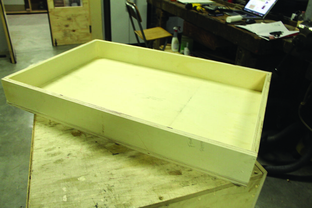 Wooden tray on workshop table