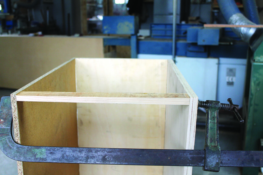 Wooden box clamped in workshop
