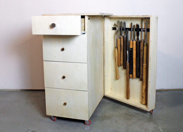 Wooden tool cabinet with open drawers and shelves.