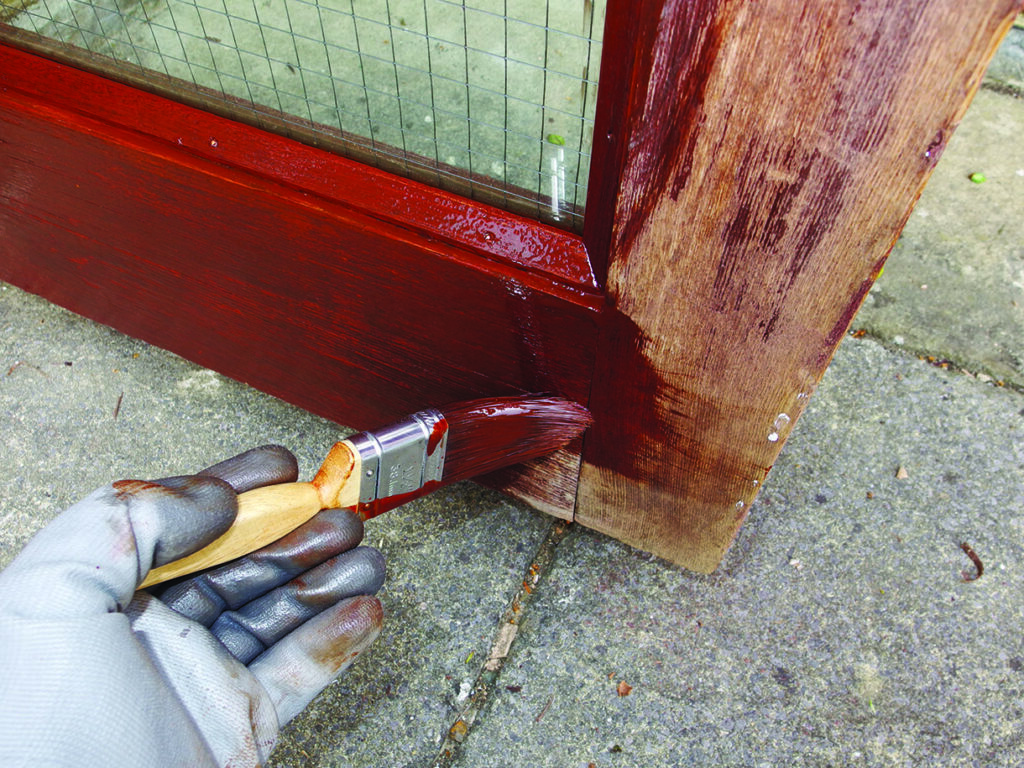 Painting wooden door frame with brush