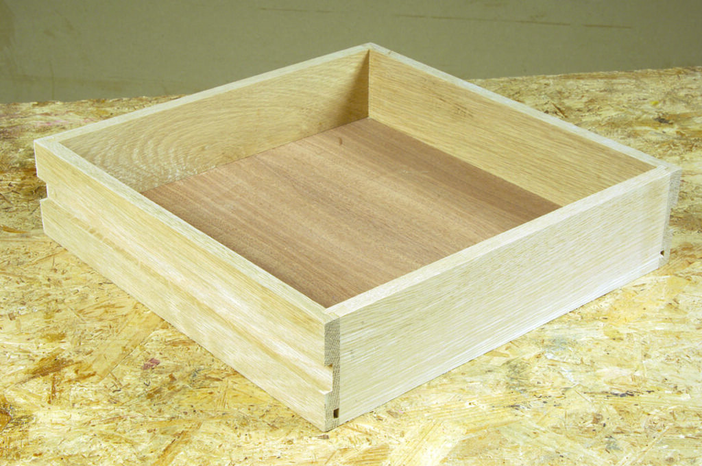 Wooden drawer box on workshop table.
