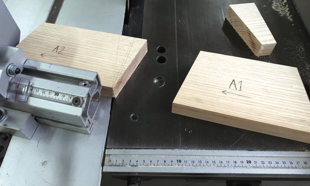 Wood pieces on a saw table with measurements.