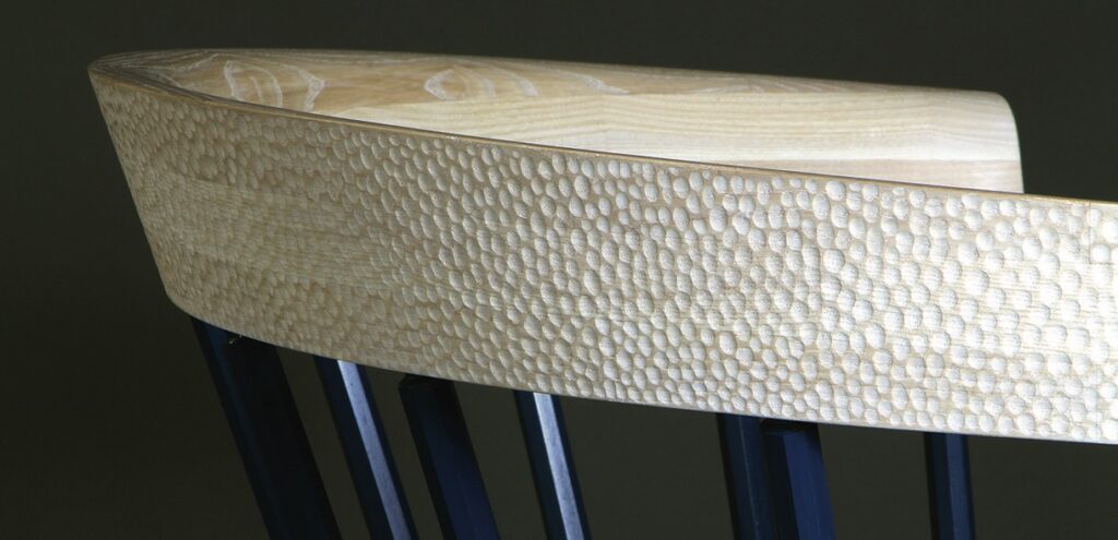 Close-up of textured wooden chair backrest