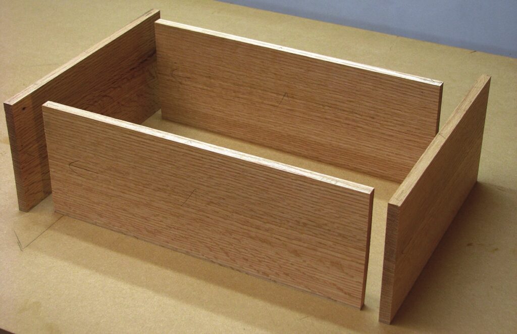 Wooden box assembly with four panels.