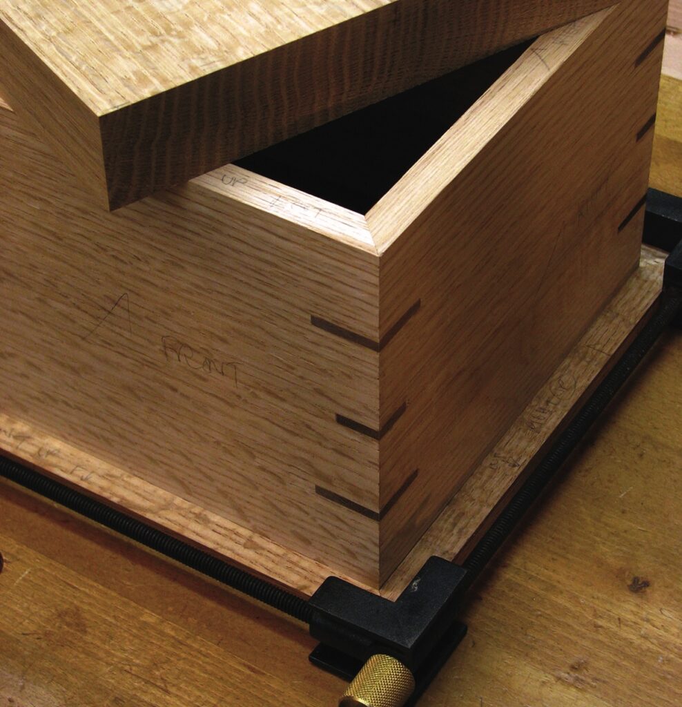 Wooden box with dovetail joints in workshop.