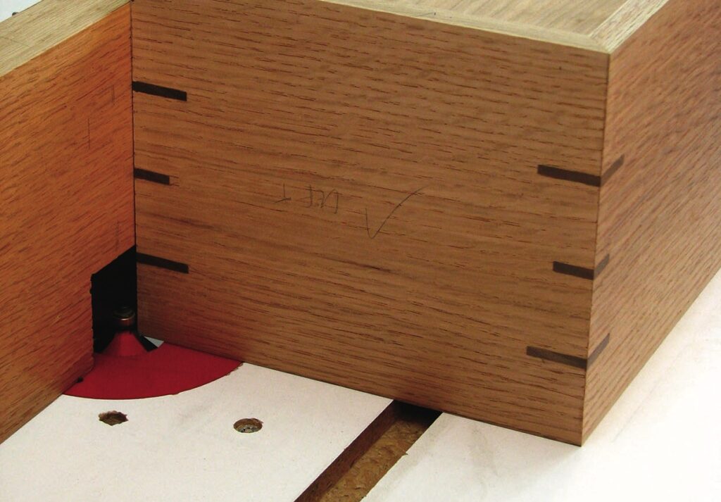 Close-up of woodworking router table setup.