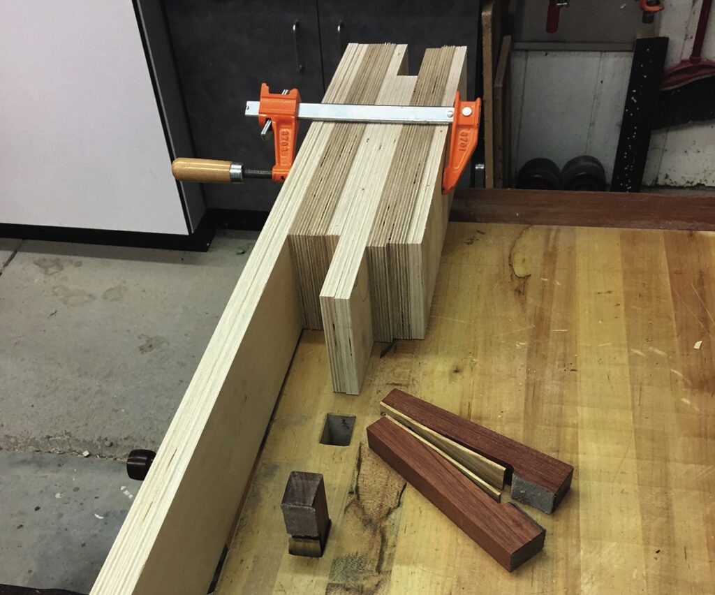 Woodworking project with clamps and wooden joints.