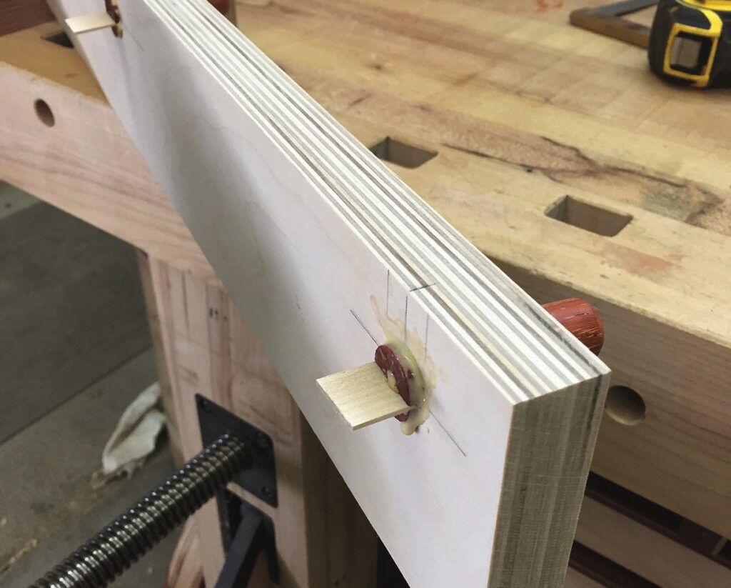 Woodworking veneer clamp on workbench.
