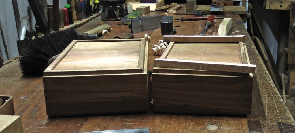 Wooden boxes on a carpentry workbench.