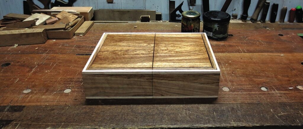 Wooden box on a craftsman's workbench.