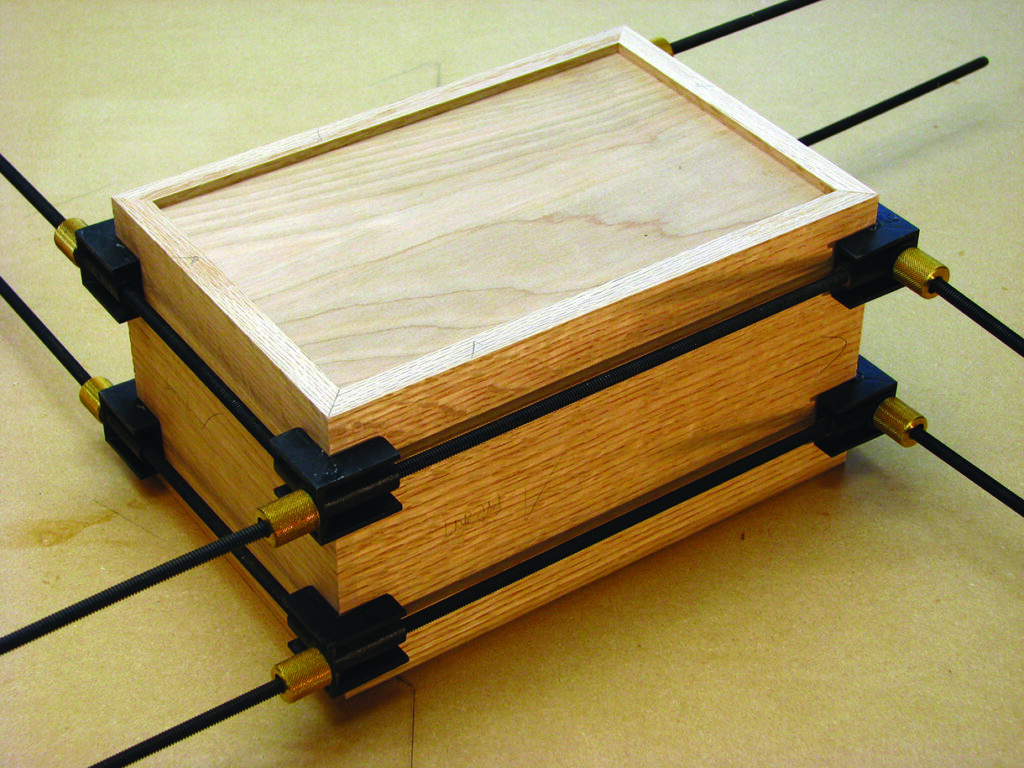 Wooden box clamped during assembly process