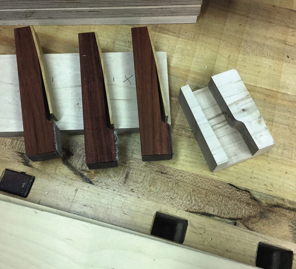 Wooden joinery pieces on workshop table.