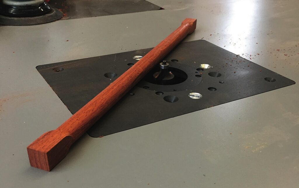 Wooden stick on a router table.
